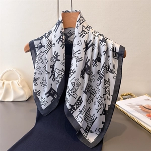 Elegant black and white printed faux silk square scarf featuring abstract animal patterns
