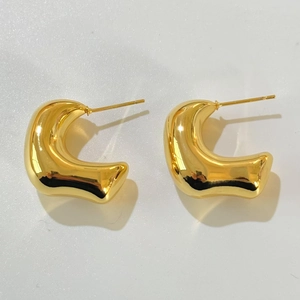 Close-up of chunky gold-plated C-shape hoop earrings with high-polish mirror finish