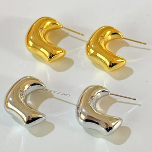 Minimalist 18K gold and silver chunky geometric hoop earrings with a fluid metal texture