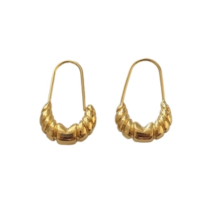 French style minimalist golden croissant earrings with twisted metal texture on white background