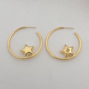 Detail of gold oversized hoop earrings featuring a central 3D star charm design