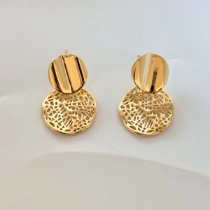 Detailed macro view of gold-plated hollow lace earrings with hammered metal texture