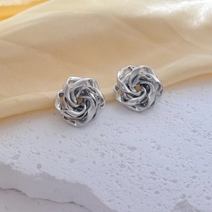 French vintage silver 3D rose earrings with wavy metal lines on a stone base