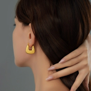 Chic gold-plated hollow U-shape geometric earrings in premium satin finish on model
