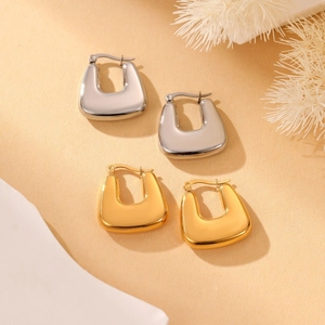 Minimalist polished gold and silver U-shaped geometric hoop earrings in a modern style