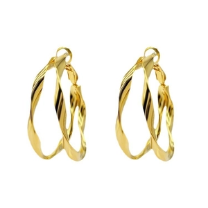 Macro detail of large gold twisted hoop earrings with a polished metallic finish