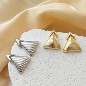 Textured triangle drop earrings in gold and silver finish with ribbed metal patterns