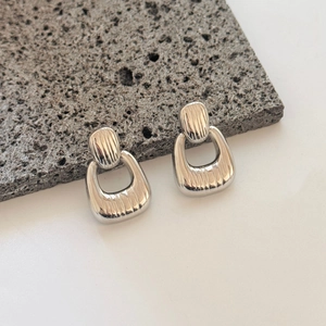 Modern geometric textured silver earrings with minimalist vertical striped pattern