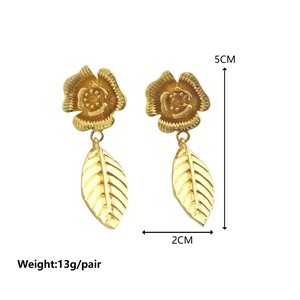 Golden flower and leaf tassel earrings with matte metallic texture and floral design