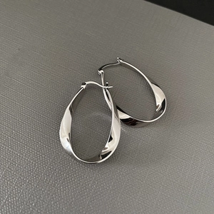 Polished silver Mobius hoop earrings with a twisted drop design and secure clasp closure