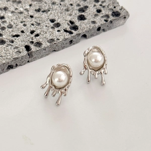 Irregular silver lava style stud earrings with round white pearl on volcanic stone