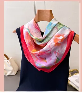 Detailed view of elegant floral faux silk scarf draped on a chic navy sleeveless top