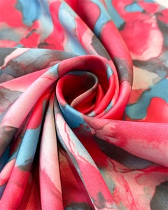 Vue macro d'un élégant foulard carré en soie avec imprimé aquarelle rouge et bleu satiné