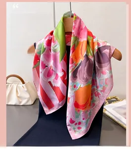 Macro shot of pink floral silk scarf featuring elegant artistic flower patterns on a hanger