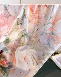 Detail showing the elegant floral pattern and silky texture of the printed square scarf