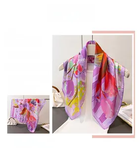Detail of elegant floral silk scarf with yellow and purple tulips print on a white hanger