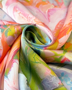 Detailed macro view of silky satin scarf fabric with vibrant floral print and elegant sheen