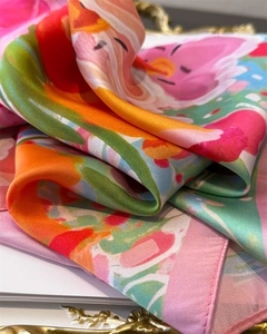 Detail shot of a printed silk scarf with satin luster and exquisite rolled edges