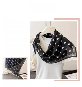 Detailed view of polka dot silk scarf tied around neck showing elegant texture and drape