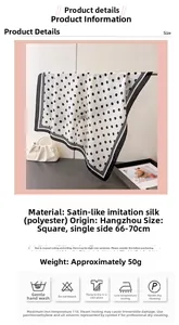 Close-up of geometric polka dot satin square scarf with elegant pearl handbag prop