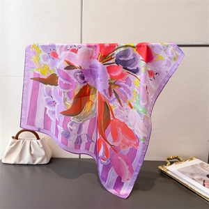 Detailed view of the silk scarf featuring artistic purple tulip prints and a fine rolled edge
