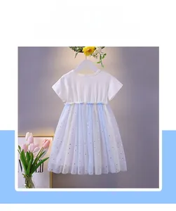 Detailed view of layered tulle skirt with golden stars on a girls' cotton dress