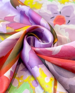 Macro shot of colorful floral print silk scarf featuring smooth satin texture and artistic drape