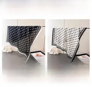 Polka dot silk-like scarves in black and white side by side for color comparison