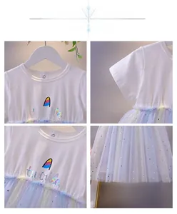 Detail of girl's white cotton dress with iridescent logo and colorful sequin mesh skirt