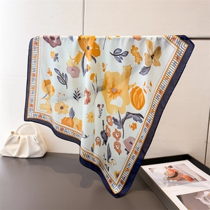 Floral and cat print silk satin square scarf with navy blue border on a hanger
