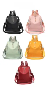 Detailed view of lightweight nylon backpacks in five vibrant colors with double zippers