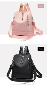 Detail view of pink and black nylon backpacks with dual zippers and studded trim