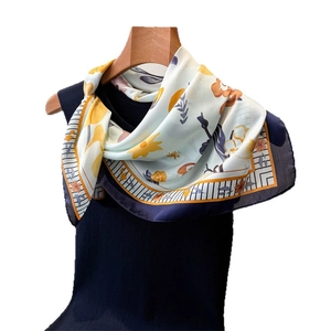 Elegant floral faux silk square scarf featuring yellow blossoms and a navy border