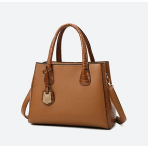 Detailed texture of brown crocodile embossed pattern and PU leather on trapezoid handbag