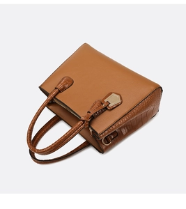 Detailed top view showing cognac brown leather texture and golden zipper on women handbag