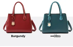 Detail of wine red and blue shoulder bags with litchi and crocodile leather texture