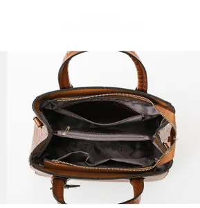 Detail view of large capacity brown bag interior with multiple zipped compartments
