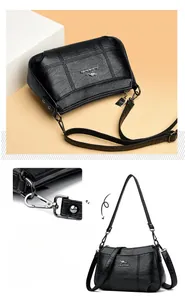 Gros plan sur les coutures du cuir et le logo kangourou du sac à bandoulière noir