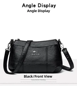 Vue détaillée du sac à main noir avec texture cuir et emblème de kangourou doré