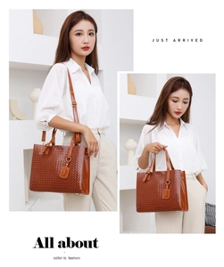 Macro view of brown woven PU leather tote bag with glossy handles and adjustable shoulder strap