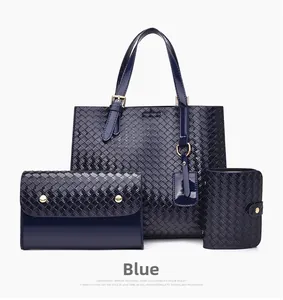 Three-piece navy blue woven tote bag set with matching clutch and purse in glossy finish