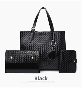 Detail of black woven 3-piece bag set with tote, clutch, and wallet in glossy finish