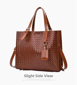 Side view of brown woven tote bag with glossy finish and gold hardware details