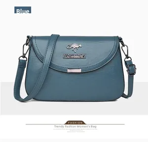 Detailed macro of blue faux leather shoulder bag with gold kangaroo emblem and metal plate