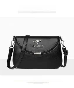 Front detail of black leather crossbody bag featuring a golden kangaroo metal logo