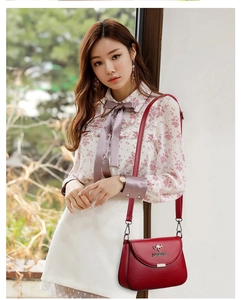 Red PU leather crossbody bag featuring a kangaroo metal logo and fine leather texture