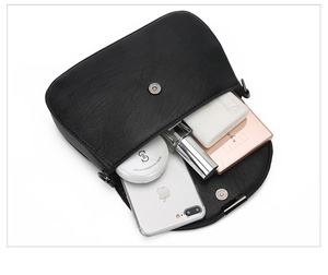 Top view showing internal capacity of the black PU crossbody bag with daily essentials