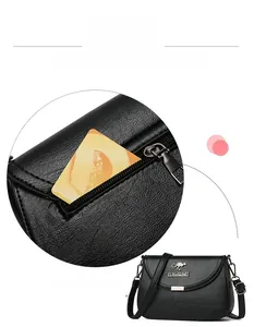 Detail of a black pebbled leather crossbody bag featuring a secure anti-theft back zipper pocket