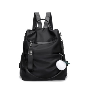 Waterproof black Oxford backpack with silver rivet straps and white fur ball pendant