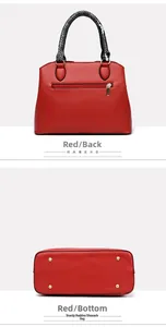 Detail view of red tote bag back zip pocket and gold metal feet on bottom base